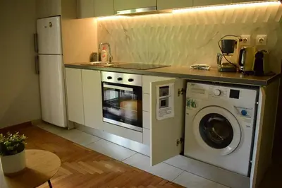 a kitchen with a washing machine and a sink at 2BA under the Acropolis Hill Athens City Center in Athens