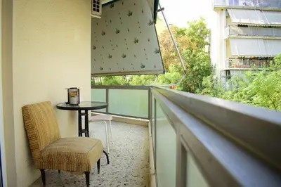 a balcony with a table and chairs and a window at 2BA under the Acropolis Hill Athens City Center in Athens