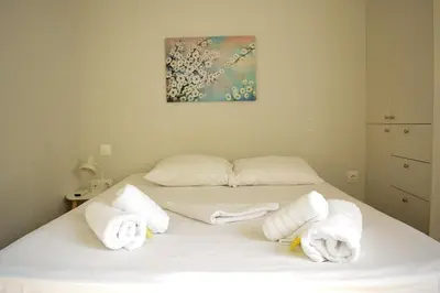 a bedroom with a bed with towels on it at 2BA under the Acropolis Hill Athens City Center in Athens