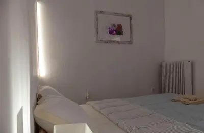 a bedroom with a bed and a picture on the wall at Sunny Penthouse in the Center of Athens in Athens