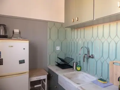 a kitchen with a sink and a refrigerator at Sunny Penthouse in the Center of Athens in Athens