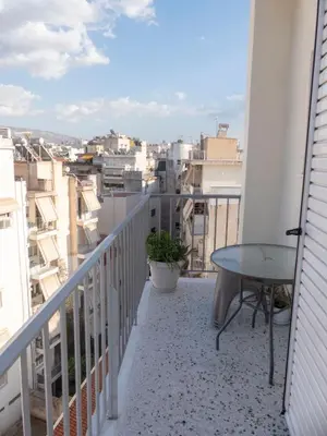a balcony with a table and a view of a city at Sunny Penthouse in the Center of Athens in Athens