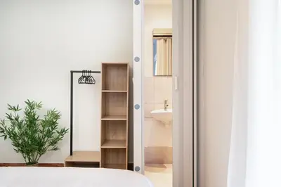 a bedroom with a mirror next to a sink at Houseloft The Viewpoint Athens in Athens