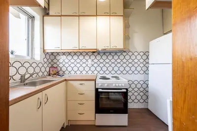 a kitchen with white cabinets and a stove and a sink at Houseloft The Viewpoint Athens in Athens