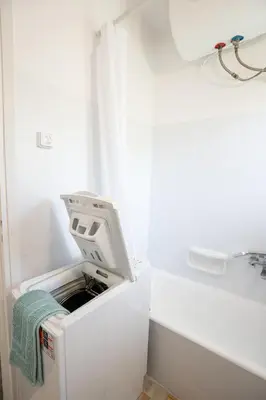 a washer and dryer in a white refrigerator at Beachfront Lagonisi Apt 1 Minute From Grand Resort in Kalívia Thorikoú