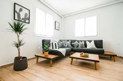 a living room with a couch and a table at Quiet room, hall, shared bathroom and kitchen in Athens