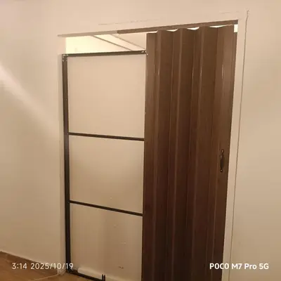 a closet with a glass door and a mirror at Quiet room, hall, shared bathroom and kitchen in Athens