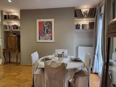 a dining room with a white table with chairs at POSEIDON Executive Suite in Athens
