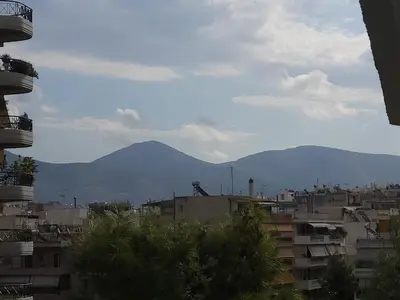 a view of a city with mountains in the background at POSEIDON Executive Suite in Athens