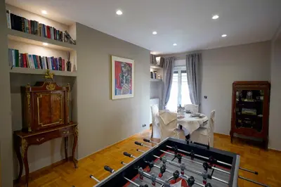 a living room with a table and a book shelf at POSEIDON Executive Suite in Athens