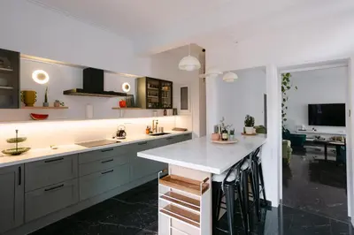a kitchen with white counters and a counter top at Unique 2BD 2BA Design Apt with airconditioning near Acropolis in Athens