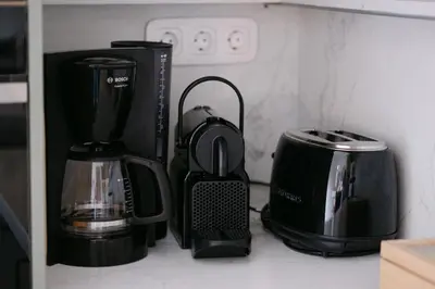 a group of appliances sitting on a kitchen counter at Unique 2BD 2BA Design Apt with airconditioning near Acropolis in Athens