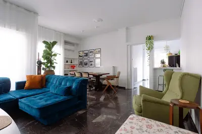 a living room with a blue couch and chairs at Unique 2BD 2BA Design Apt with airconditioning near Acropolis in Athens