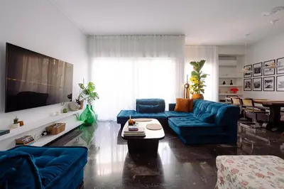 a living room with blue couches and a table at Unique 2BD 2BA Design Apt with airconditioning near Acropolis in Athens