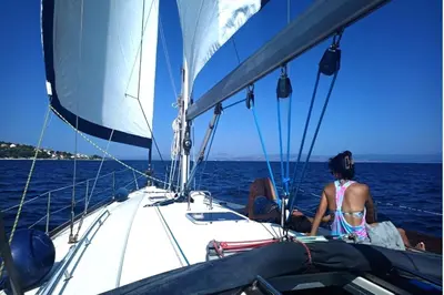 a woman on a sail boat in the water at Sailing boat house in Athens