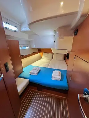 a small cabin with two towels on a blue bed at Sailing boat house in Athens