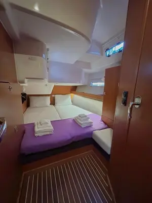 a small room with a purple bed in a boat at Sailing boat house in Athens