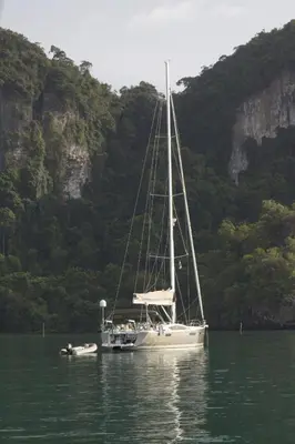 a sailboat is sitting in the water near a mountain at Sailing boat house in Athens