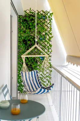 a hanging hammock on a balcony with a green wall at Stylish Luxury Getaway 3BR Apartment 115m in Athens
