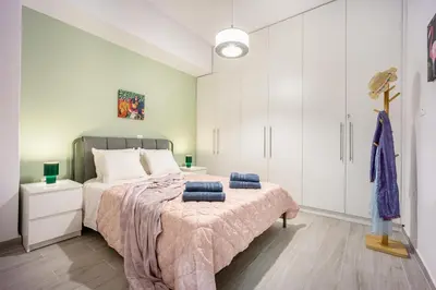 a bedroom with a large bed and white cabinets at Stylish Luxury Getaway 3BR Apartment 115m in Athens