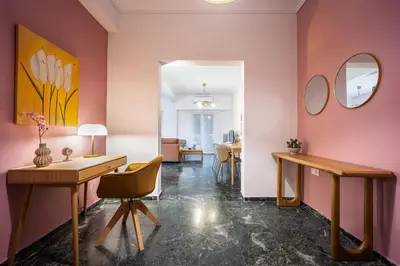 a room with pink walls and a desk and a chair at Stylish Luxury Getaway 3BR Apartment 115m in Athens