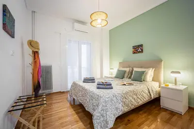 a bedroom with a bed with a white bedspread at Stylish Luxury Getaway 3BR Apartment 115m in Athens