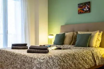 a bed with two stacks of towels on it at Stylish Luxury Getaway 3BR Apartment 115m in Athens