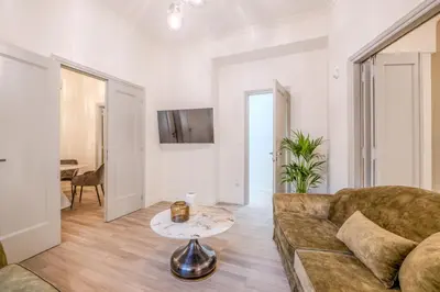 a living room with a couch and a table at The Athenian Elegance , Luxury 2 br near Hilton District in Athens