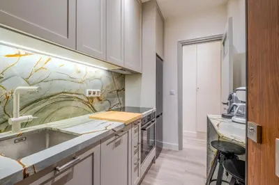a kitchen with white cabinets and a sink at The Athenian Elegance , Luxury 2 br near Hilton District in Athens