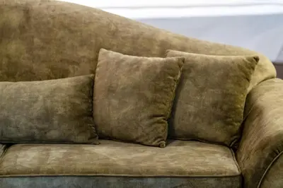 a brown couch with three pillows on it at The Athenian Elegance , Luxury 2 br near Hilton District in Athens