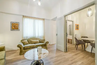 a living room with a couch and a table at The Athenian Elegance , Luxury 2 br near Hilton District in Athens