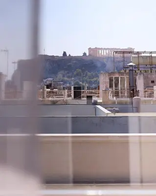 a view of a city from a window at Acropolis view modern studio in Athens