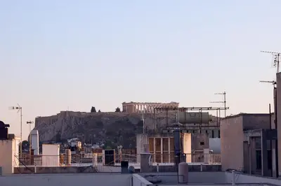 a view of a city with a hill in the background at Acropolis view modern studio in Athens