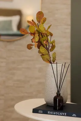 a vase with a plant in it on a table at Acropolis view modern studio in Athens