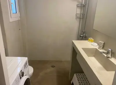 a white bathroom with a sink and a toilet at Lydia Apartment Comfortable 2BR near Hospital in Athens