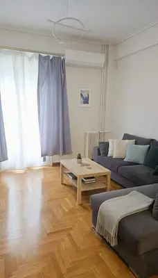 a living room with a couch and a coffee table at Lydia Apartment Comfortable 2BR near Hospital in Athens