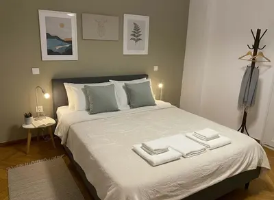 a bedroom with a large bed with three towels on it at Elektra Residence 2Bd Apartment in Monastiraki in Athens