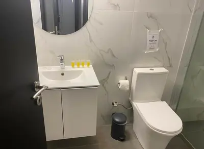 a bathroom with a toilet and a sink and a mirror at Elektra Residence 2Bd Apartment in Monastiraki in Athens