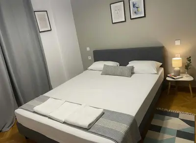a bedroom with a large bed with white sheets and pillows at Elektra Residence 2Bd Apartment in Monastiraki in Athens