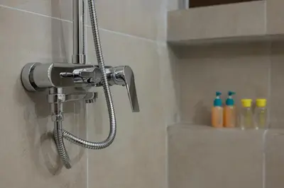 a shower with a shower head in a bathroom at Spacious & central 2BR apt in Agia Paraskevi in Athens