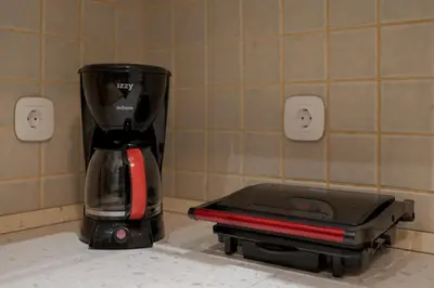 a black and red blender sitting on a counter at Spacious & central 2BR apt in Agia Paraskevi in Athens