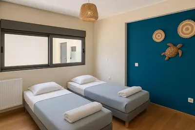 a room with two beds and a window at Deep Blue Luxury Escape Heated Pool & Sea View in Saronida