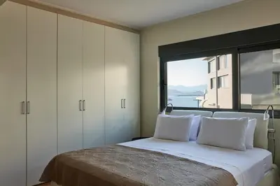 a bedroom with a bed with a large window at Deep Blue Luxury Escape Heated Pool & Sea View in Saronida