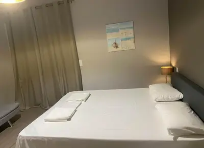 a bedroom with a large bed with two white pillows at Under the Gaze of the Acropolis 2-Bb Athenian Apt in Athens