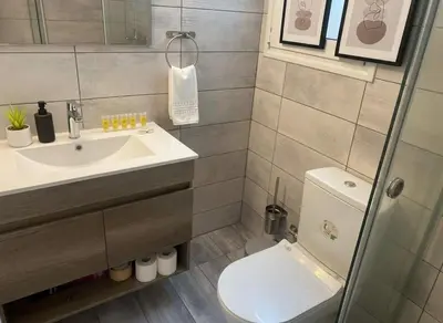 a bathroom with a sink and a toilet at Under the Gaze of the Acropolis 2-Bb Athenian Apt in Athens
