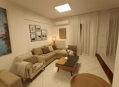 a living room with a couch and a coffee table at Modern Ease by the CoastFaliro 2Bed Gem in Athens