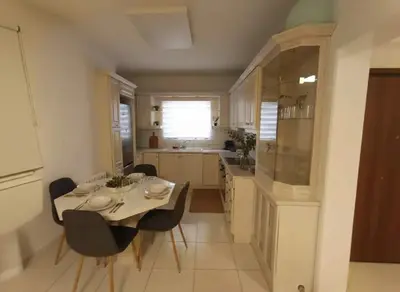 a kitchen and dining room with a table and chairs at Modern Ease by the CoastFaliro 2Bed Gem in Athens