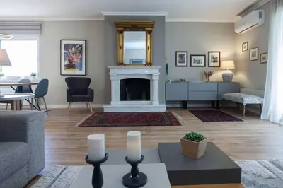 a living room with a fireplace and a couch at Waves of Comfort Premium 3-Bd Stay in Alimos in Athens