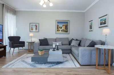 a living room with a couch and a table at Waves of Comfort Premium 3-Bd Stay in Alimos in Athens