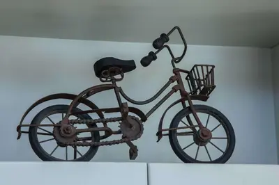 a statue of a bicycle hanging on a wall at Waves of Comfort Premium 3-Bd Stay in Alimos in Athens